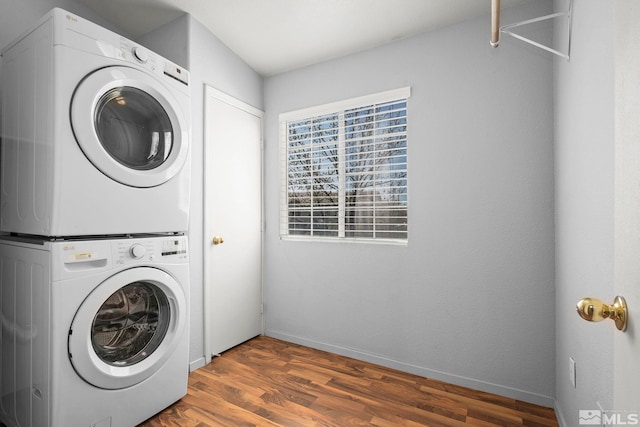 5645 Vista Luna Dr Apt 101, Sparks, NV 89436 - laundry room with stacked washing machine and dryer, wood finished floors, and baseboards