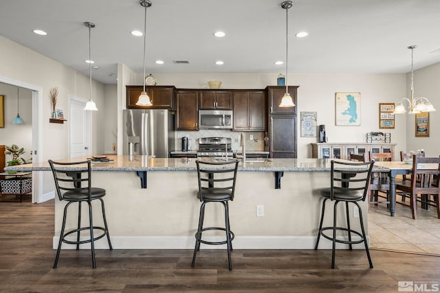 780 Ahwanee Dr, Sparks, NV 89436 - kitchen with appliances with stainless steel finishes, dark brown cabinetry, dark wood-type flooring, and recessed lighting