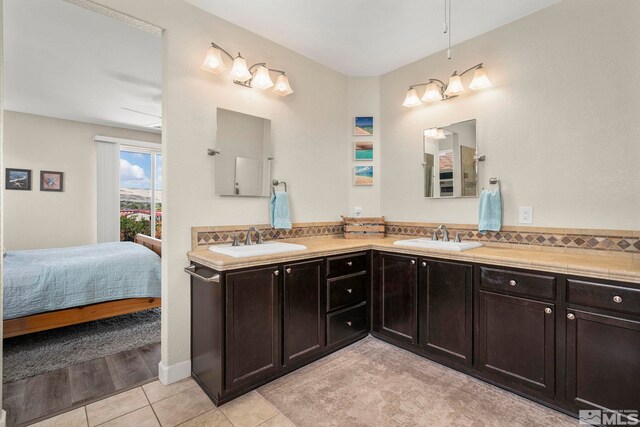 780 Ahwanee Dr, Sparks, NV 89436 - bathroom featuring connected bathroom, double vanity, tile patterned flooring, and tasteful backsplash