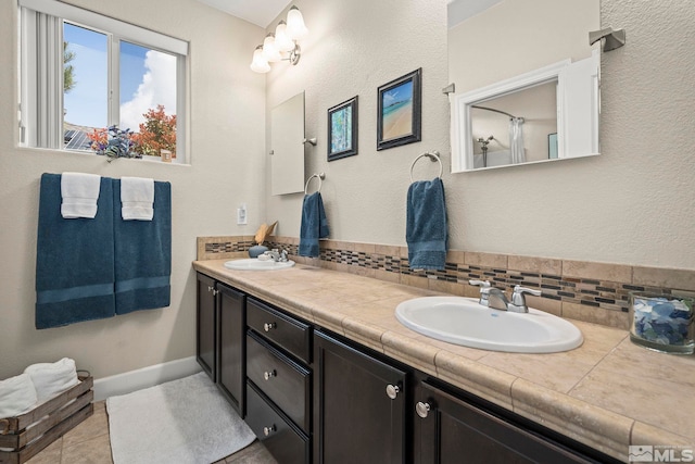 780 Ahwanee Dr, Sparks, NV 89436 - full bath with double vanity, tile patterned floors, and decorative backsplash