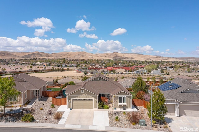 780 Ahwanee Dr, Sparks, NV 89436 - view of front of house featuring concrete driveway, a mountain view, fence, and a residential view