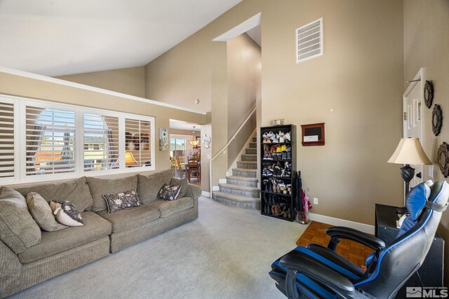 8127 Anchor Point Dr, Reno, NV 89506 - living area with stairway, baseboards, high vaulted ceiling, and carpet flooring