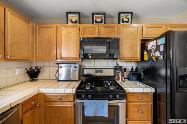 8127 Anchor Point Dr, Reno, NV 89506 - kitchen with black appliances, tile counters, and decorative backsplash