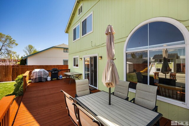 8127 Anchor Point Dr, Reno, NV 89506 - deck featuring outdoor dining area, fence, and grilling area