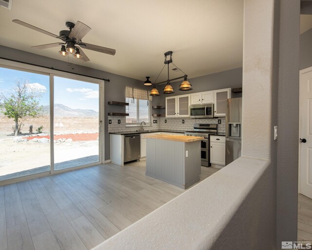 326 Torrey Pines Dr, Dayton, NV 89403 - kitchen with appliances with stainless steel finishes, butcher block counters, open shelves, a kitchen island, and ceiling fan