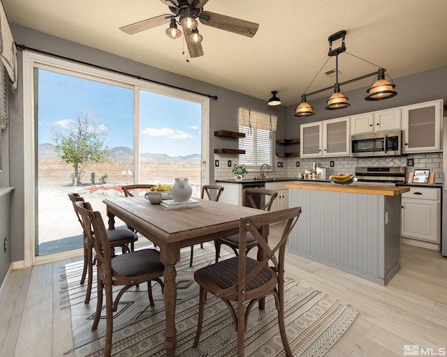 326 Torrey Pines Dr, Dayton, NV 89403 - dining room featuring a mountain view, a ceiling fan, and light wood-type flooring