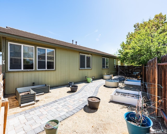 326 Torrey Pines Dr, Dayton, NV 89403 - back of house featuring a vegetable garden, a patio, and a fenced backyard