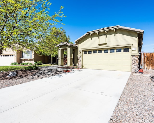 326 Torrey Pines Dr, Dayton, NV 89403 - single story home featuring stone siding, driveway, an attached garage, and fence