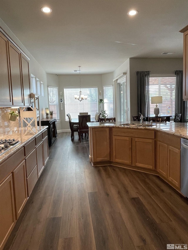 684 Rose Ln, Fernley, NV 89408 - kitchen featuring dark wood-style flooring, recessed lighting, a chandelier, a sink, and light stone countertops