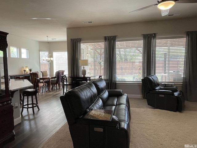 684 Rose Ln, Fernley, NV 89408 - living room with a chandelier, a ceiling fan, baseboards, and wood finished floors