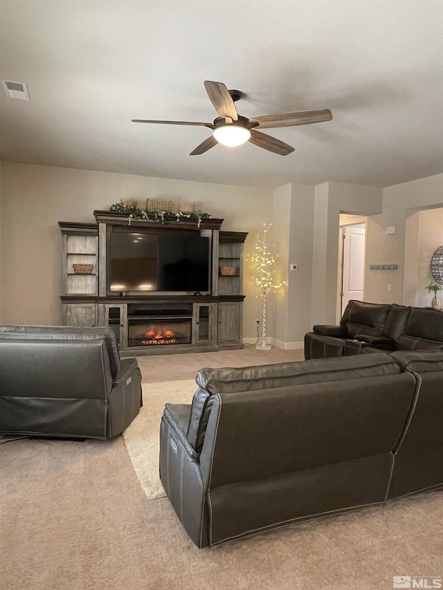 684 Rose Ln, Fernley, NV 89408 - carpeted living area featuring ceiling fan and a glass covered fireplace