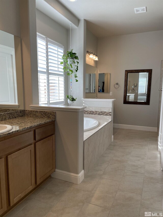 684 Rose Ln, Fernley, NV 89408 - bathroom with a garden tub, baseboards, vanity, and tile patterned floors