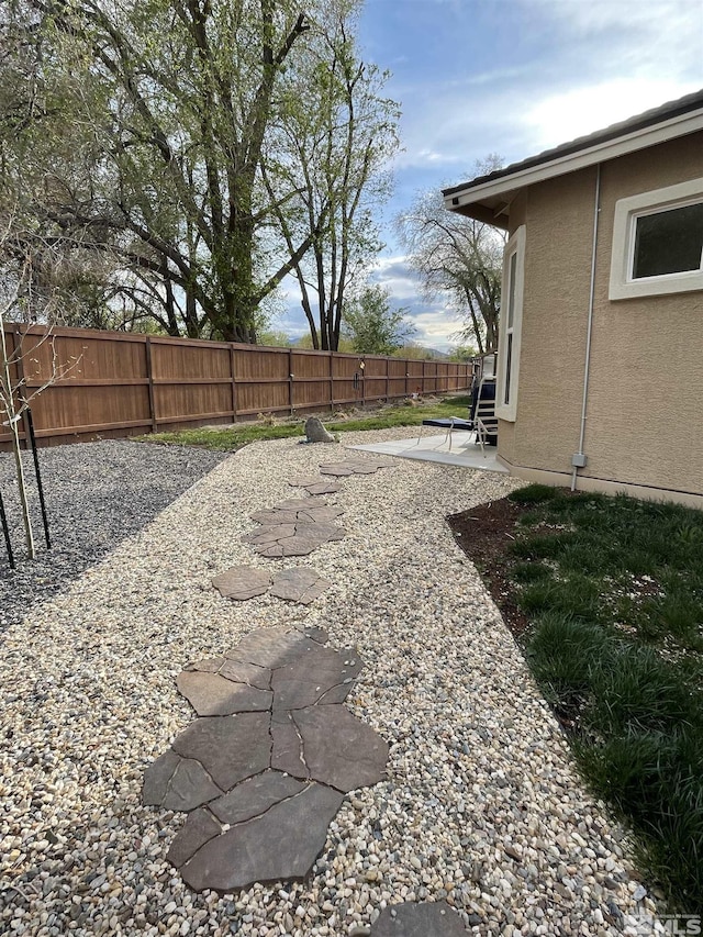 684 Rose Ln, Fernley, NV 89408 - fenced backyard with a patio area