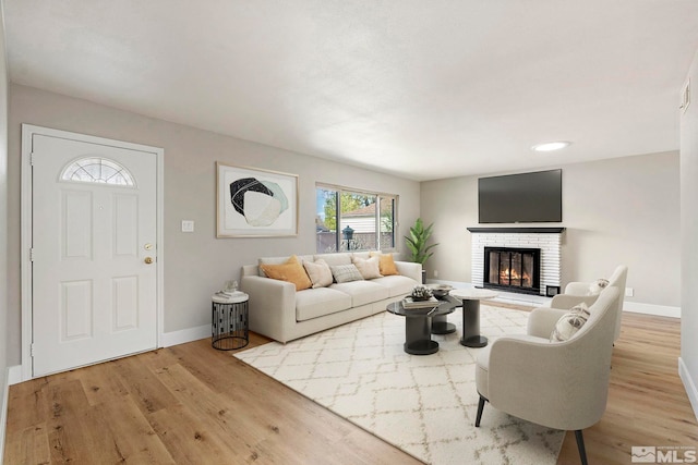 1365 Prospect Ave, Sparks, NV 89431 - living area featuring baseboards, light wood finished floors, and a brick fireplace