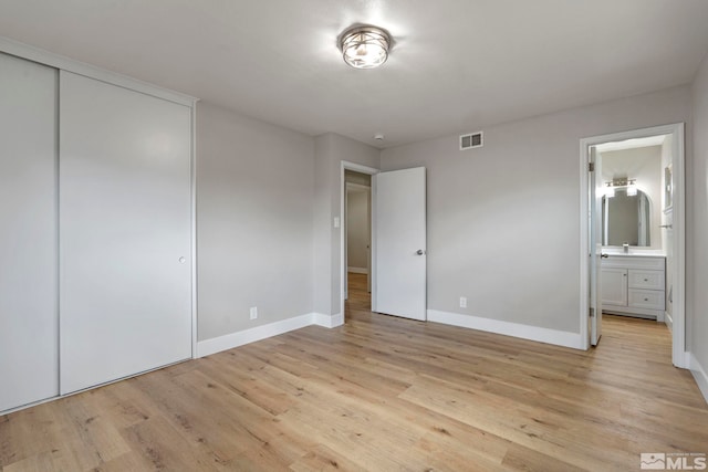 1365 Prospect Ave, Sparks, NV 89431 - unfurnished bedroom with light wood-style floors, baseboards, and ensuite bath