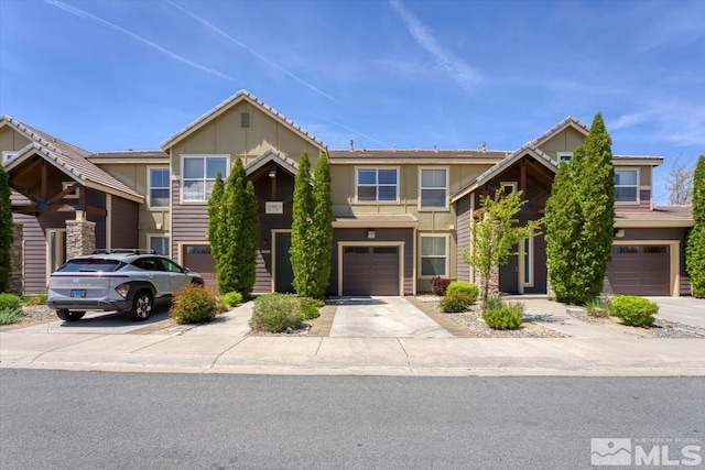4889 Bougainvillea Cir, Sparks, NV 89436 - view of front of property featuring driveway, an attached garage, and board and batten siding