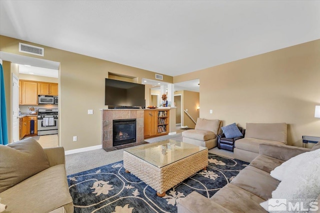 4889 Bougainvillea Cir, Sparks, NV 89436 - living room featuring light carpet, baseboards, and a tiled fireplace