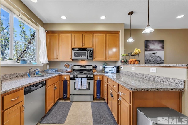 4889 Bougainvillea Cir, Sparks, NV 89436 - kitchen featuring appliances with stainless steel finishes, a peninsula, plenty of natural light, a sink, and recessed lighting