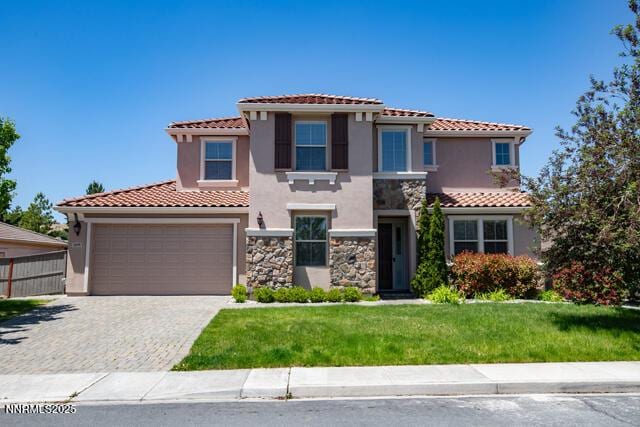 1095 S University Park Loop, Reno, NV 89512 - mediterranean / spanish house featuring stucco siding, a tile roof, decorative driveway, stone siding, and a garage