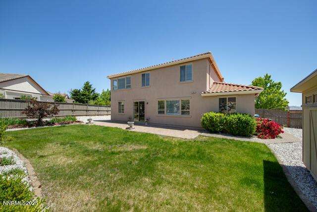 1095 S University Park Loop, Reno, NV 89512 - back of property with a tile roof, stucco siding, and a patio area