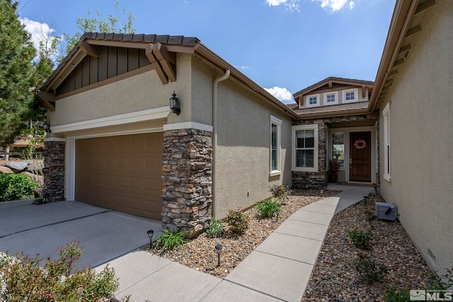 2370 Hickory Hl, Reno, NV 89523 - view of home's exterior with stone siding, stucco siding, concrete driveway, and a garage