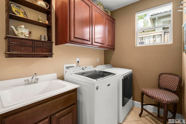 2370 Hickory Hl, Reno, NV 89523 - clothes washing area with washer and clothes dryer, cabinet space, and light tile patterned flooring