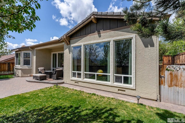 2370 Hickory Hl, Reno, NV 89523 - back of house with a patio area, stucco siding, and board and batten siding