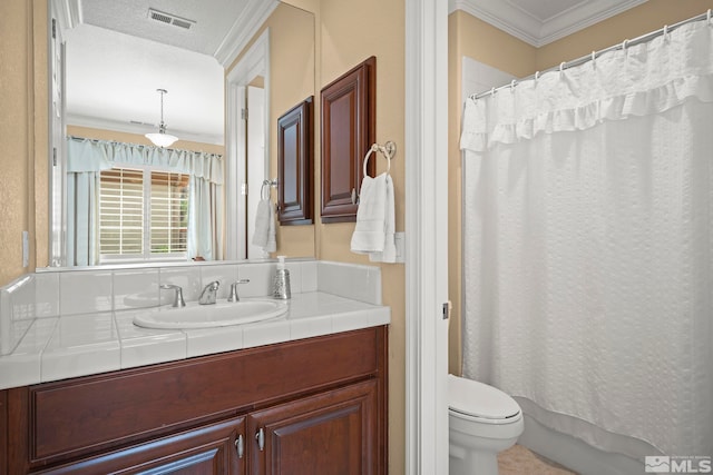 bathroom with crown molding, toilet, vanity, and a shower with shower curtain