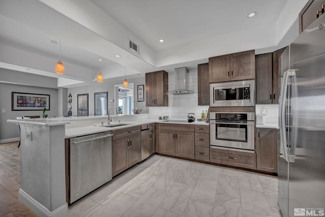 200 W 2nd St Unit 1202, Reno, NV 89501 - kitchen featuring appliances with stainless steel finishes, a sink, wall chimney range hood, a peninsula, and light countertops