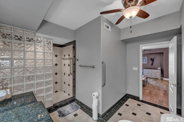 200 W 2nd St Unit 1202, Reno, NV 89501 - full bath with walk in shower, baseboards, inlaid floor details, a ceiling fan, and tile patterned floors