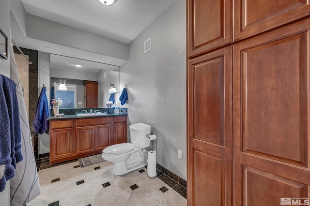 200 W 2nd St Unit 1202, Reno, NV 89501 - bathroom with toilet, baseboards, vanity, and tile patterned flooring