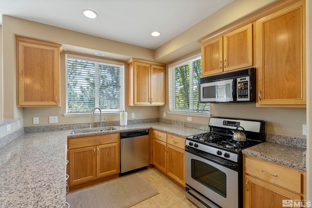 4845 Bougainvillea Cir, Sparks, NV 89436 - kitchen with appliances with stainless steel finishes, a sink, light stone counters, recessed lighting, and light tile patterned flooring