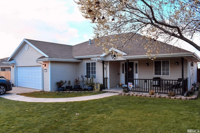 ranch-style home featuring covered porch, a front yard, and an attached garage