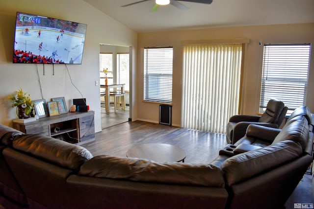 living area with a ceiling fan, vaulted ceiling, wood finished floors, and baseboards
