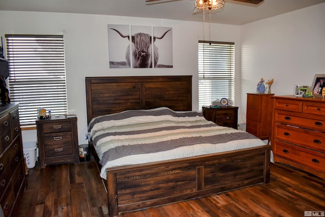 bedroom with dark wood-type flooring and a ceiling fan