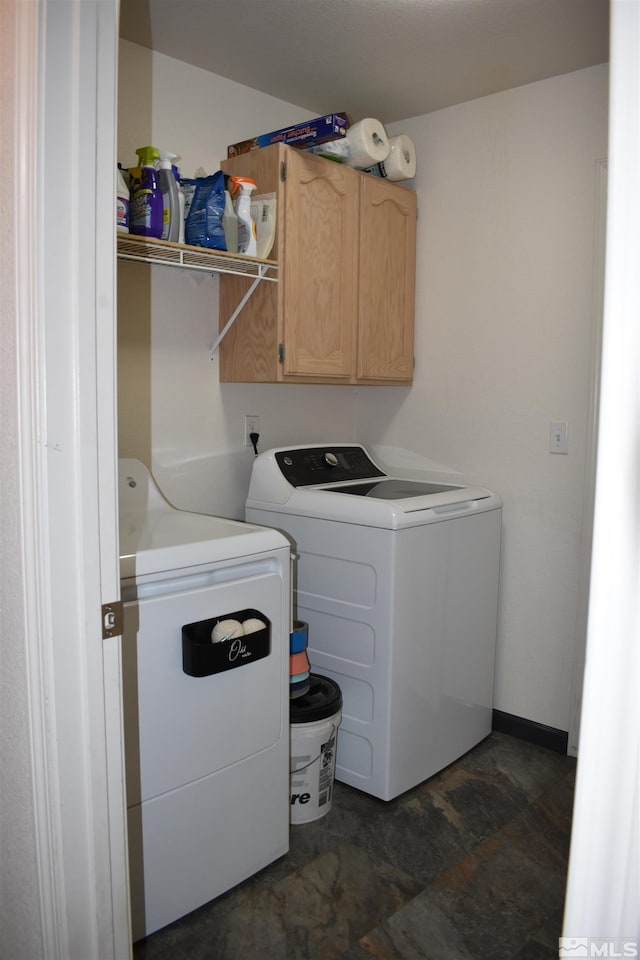 laundry area featuring separate washer and dryer and cabinet space
