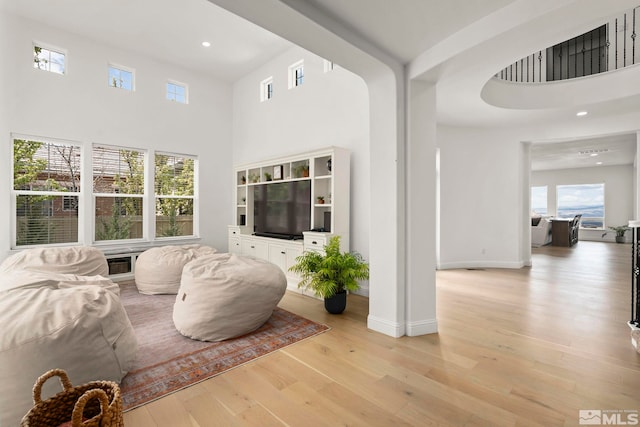 10198 Via Como, Reno, NV 89511 - living area with a towering ceiling, light wood-style floors, plenty of natural light, recessed lighting, and baseboards