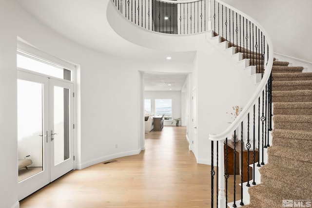 10198 Via Como, Reno, NV 89511 - entrance foyer with wood finished floors, french doors, stairs, baseboards, and a towering ceiling