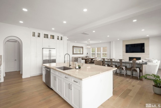 10198 Via Como, Reno, NV 89511 - kitchen with a sink, stainless steel appliances, light wood-style flooring, an island with sink, and recessed lighting