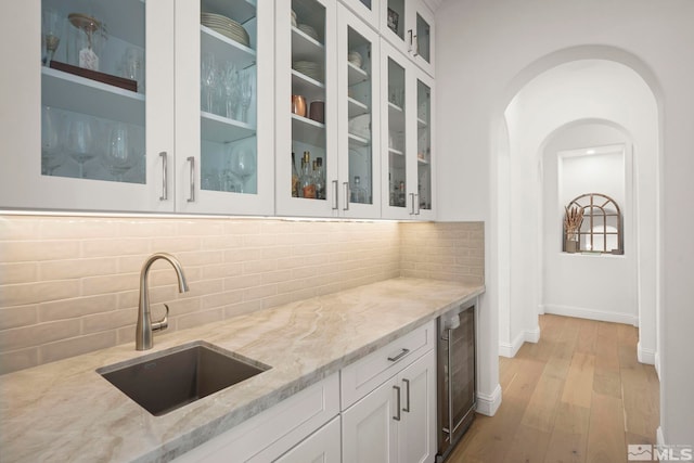 10198 Via Como, Reno, NV 89511 - bar featuring wine cooler, a sink, backsplash, and light wood finished floors