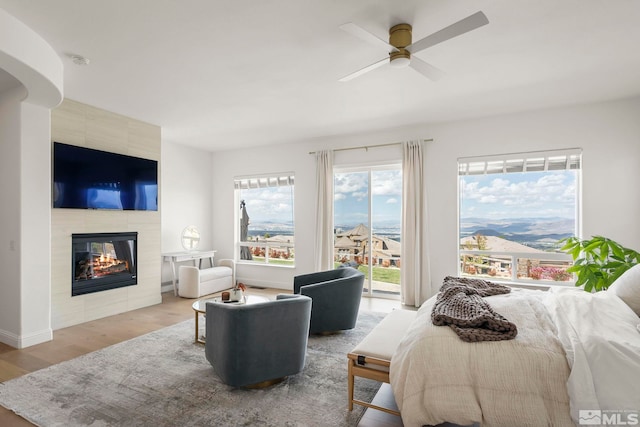 10198 Via Como, Reno, NV 89511 - bedroom with access to outside, light wood-style floors, a tile fireplace, and baseboards