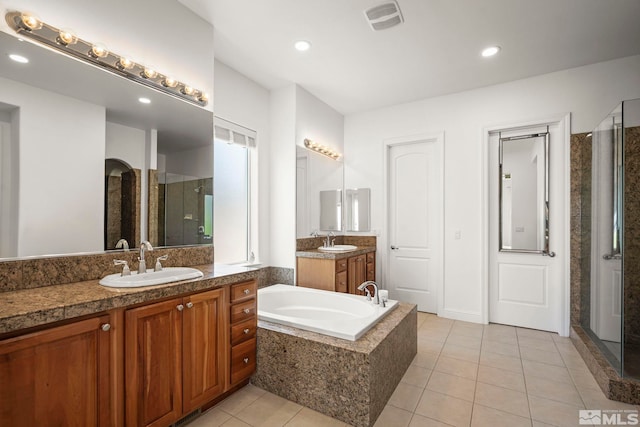 10198 Via Como, Reno, NV 89511 - full bath with a stall shower, tile patterned floors, a garden tub, two vanities, and recessed lighting