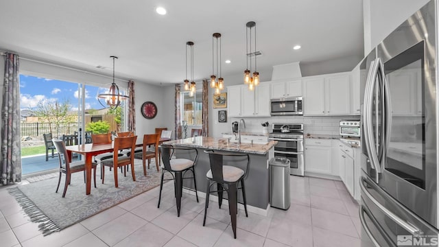 2282 Selway Dr, Sparks, NV 89436 - kitchen featuring stainless steel appliances, tasteful backsplash, light stone countertops, recessed lighting, and white cabinets
