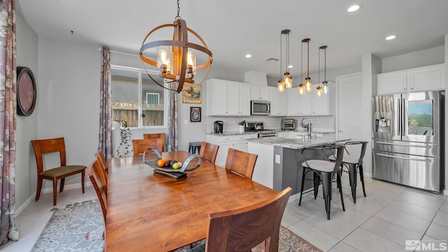 2282 Selway Dr, Sparks, NV 89436 - dining area with a chandelier, recessed lighting, light tile patterned floors, and baseboards