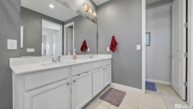 2282 Selway Dr, Sparks, NV 89436 - full bathroom featuring double vanity, a textured wall, tile patterned floors, and baseboards