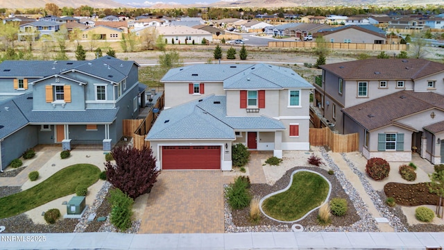 2282 Selway Dr, Sparks, NV 89436 - view of front of home featuring a residential view, decorative driveway, stucco siding, a mountain view, and a garage