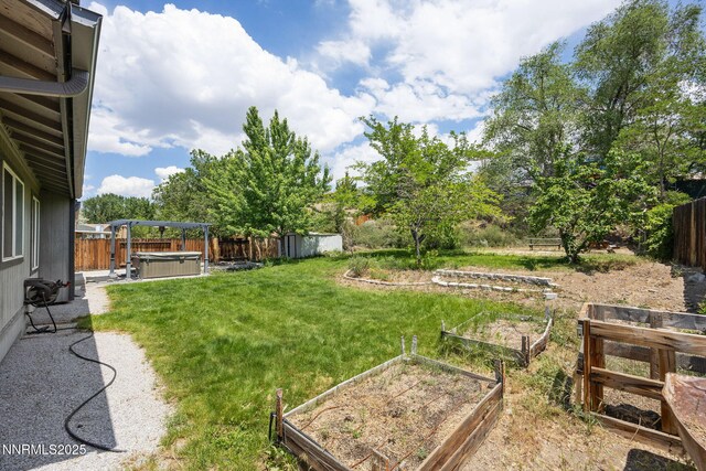 2120 Keystone Ave, Reno, NV 89503 - fenced backyard featuring a hot tub and a vegetable garden