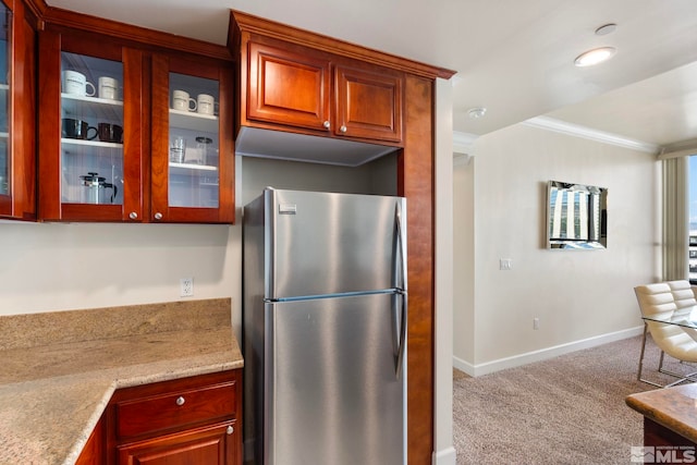 450 N Arlington Unit 1403, Reno, NV 89503 - kitchen with freestanding refrigerator, carpet floors, glass insert cabinets, crown molding, and baseboards