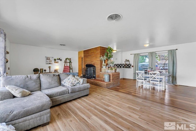 445 S Bailey, Fallon, NV 89406 - living room with light wood-style flooring and a fireplace