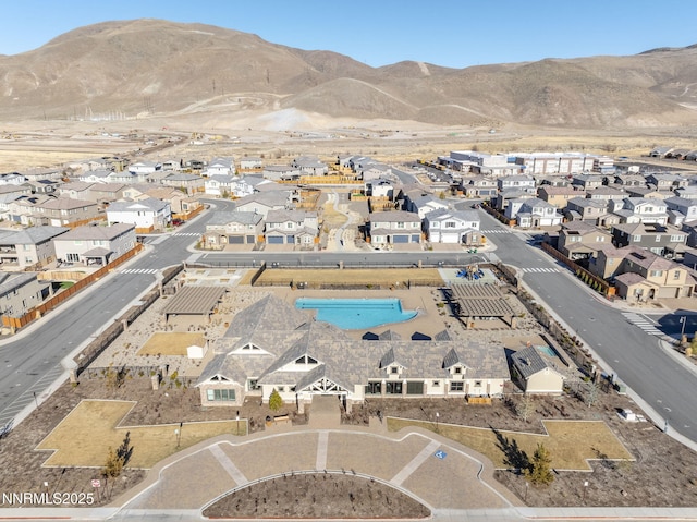 9713 Silverspar St, Reno, NV 89521 - aerial view of property and surrounding area featuring nearby suburban area, a mountainous background, and a pool area
